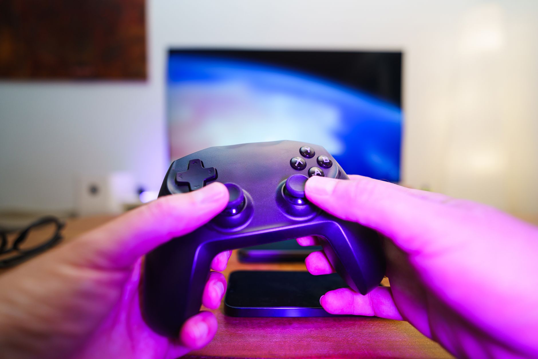 Close-up of hands holding a game controller in front of a TV screen. Perfect for entertainment setups. — 15 Proven Strategies