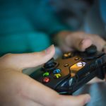 Hands gripping a modern wireless gaming controller indoors. Perfect for tech enthusiasts. — Direct Big Provider Slot Websites