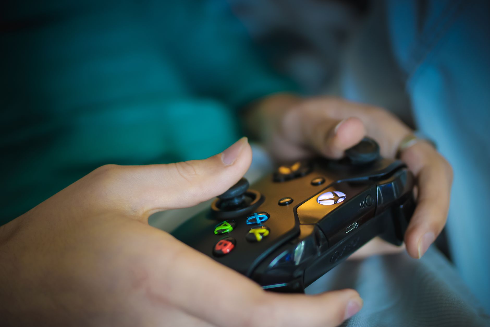 Hands gripping a modern wireless gaming controller indoors. Perfect for tech enthusiasts. — Direct Big Provider Slot Websites