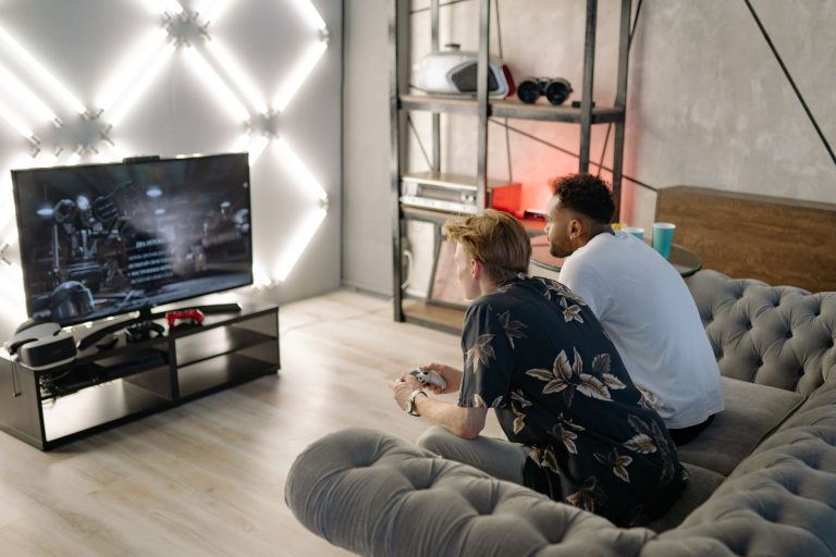 Two young men gaming together in a stylish modern living room with a large TV. — Expert Strategies for Meaningful Matches Usi