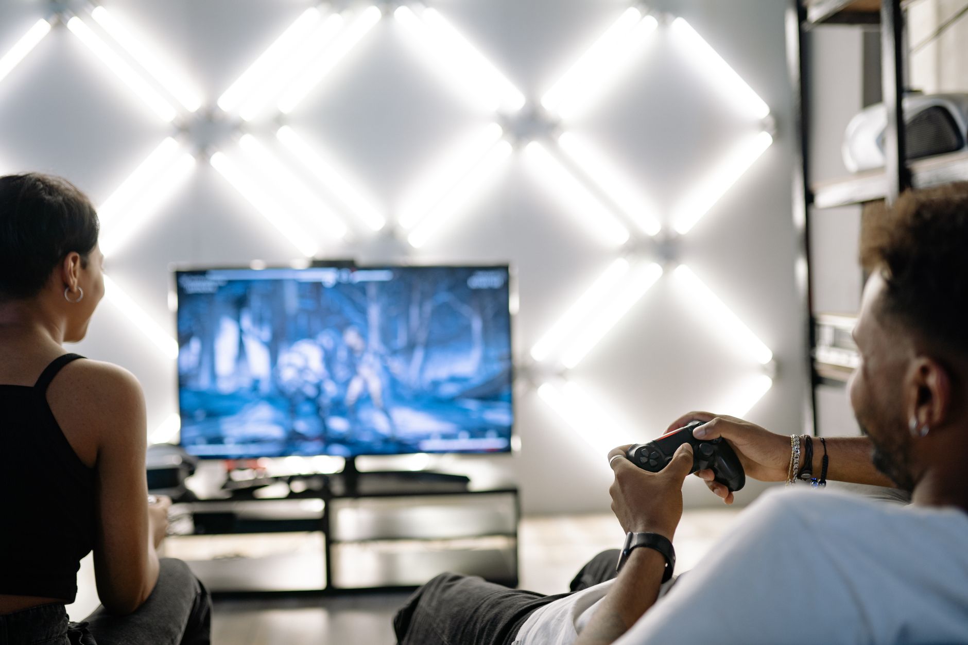 Two adults are having fun playing video games in a stylish, modern living room with LED lighting. — Unleashing the Power of W